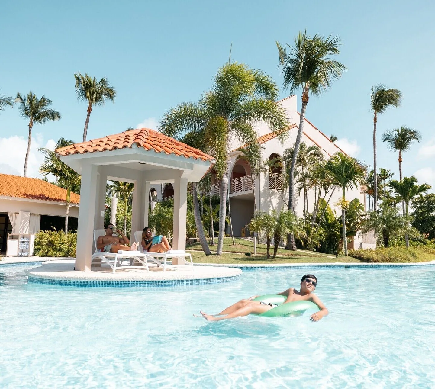 Guests relax in and beside the pool at Wyndham Palmas Beach and Golf Boutique Resort.
