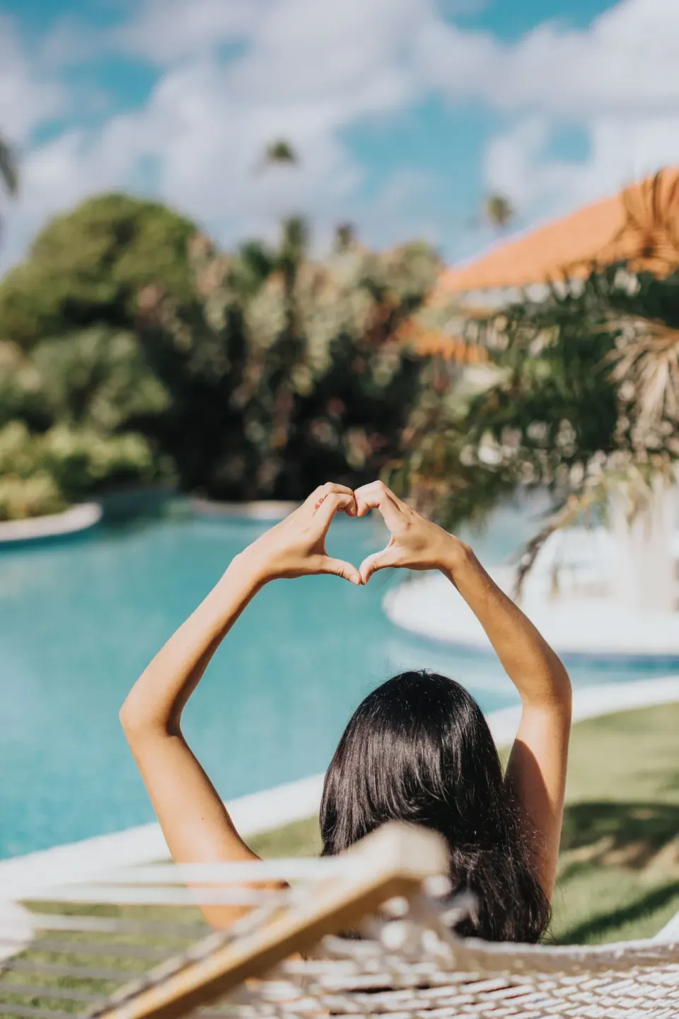 Poolside guest making a heart gesture at Wyndham Palmas Beach and Golf Boutique Resort.