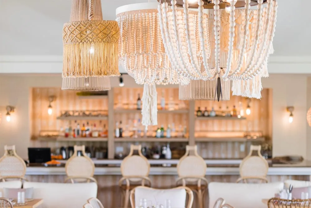 Bar and dining area with woven pendant lights at Wyndham Palmas Beach and Golf Boutique Resort.