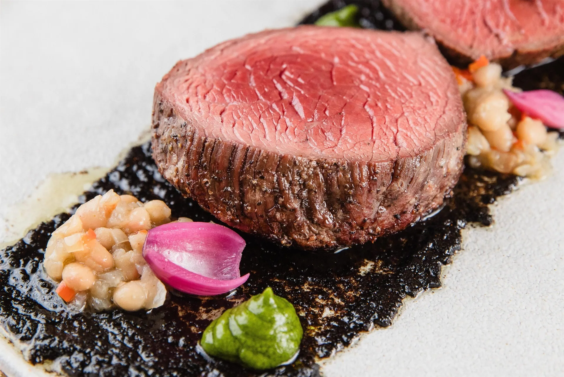 Seared beef with sauce and garnishes at Wyndham Palmas Beach and Golf Boutique Resort.