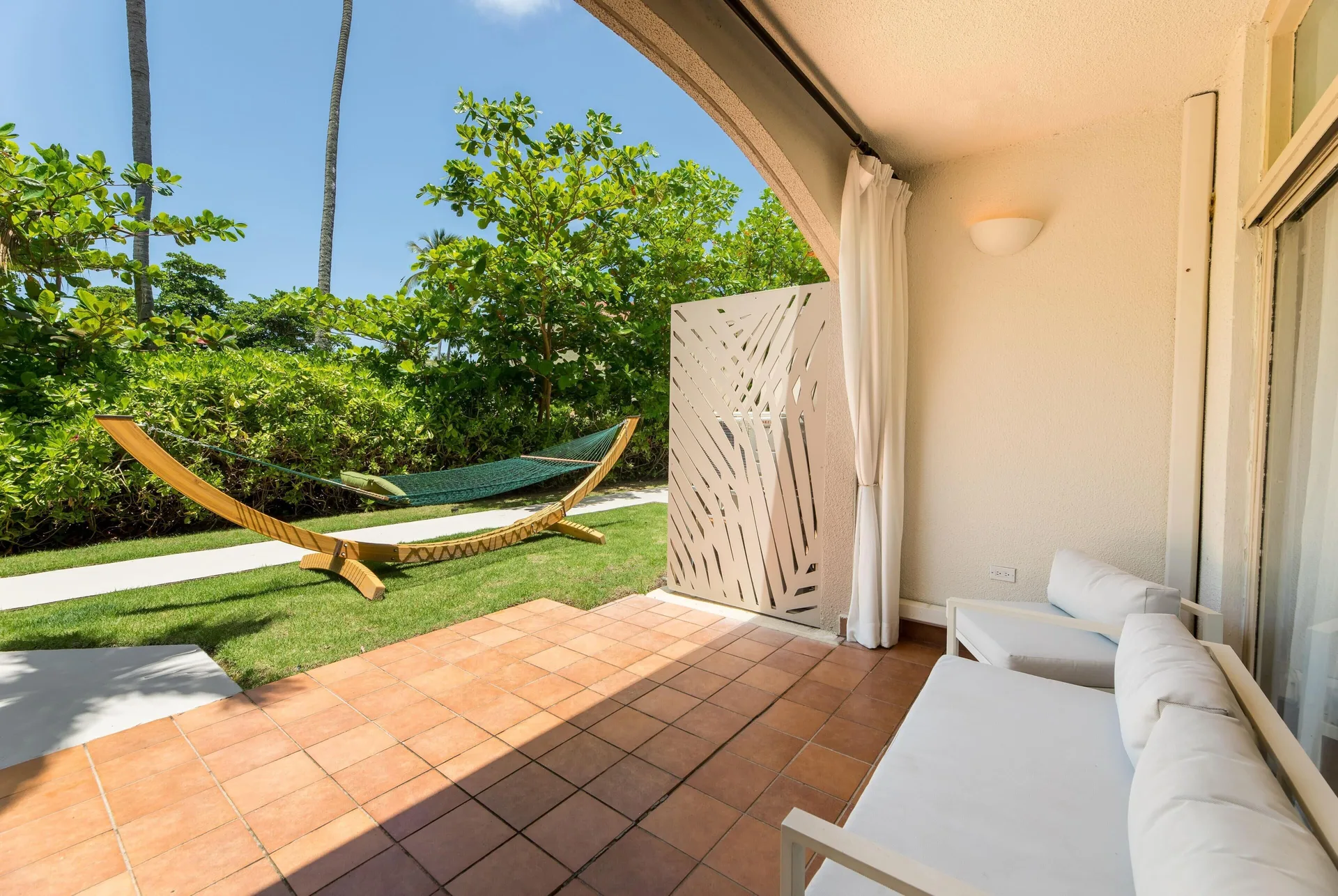 Private garden patio with hammock and seating at Wyndham Palmas Beach and Golf Boutique Resort.