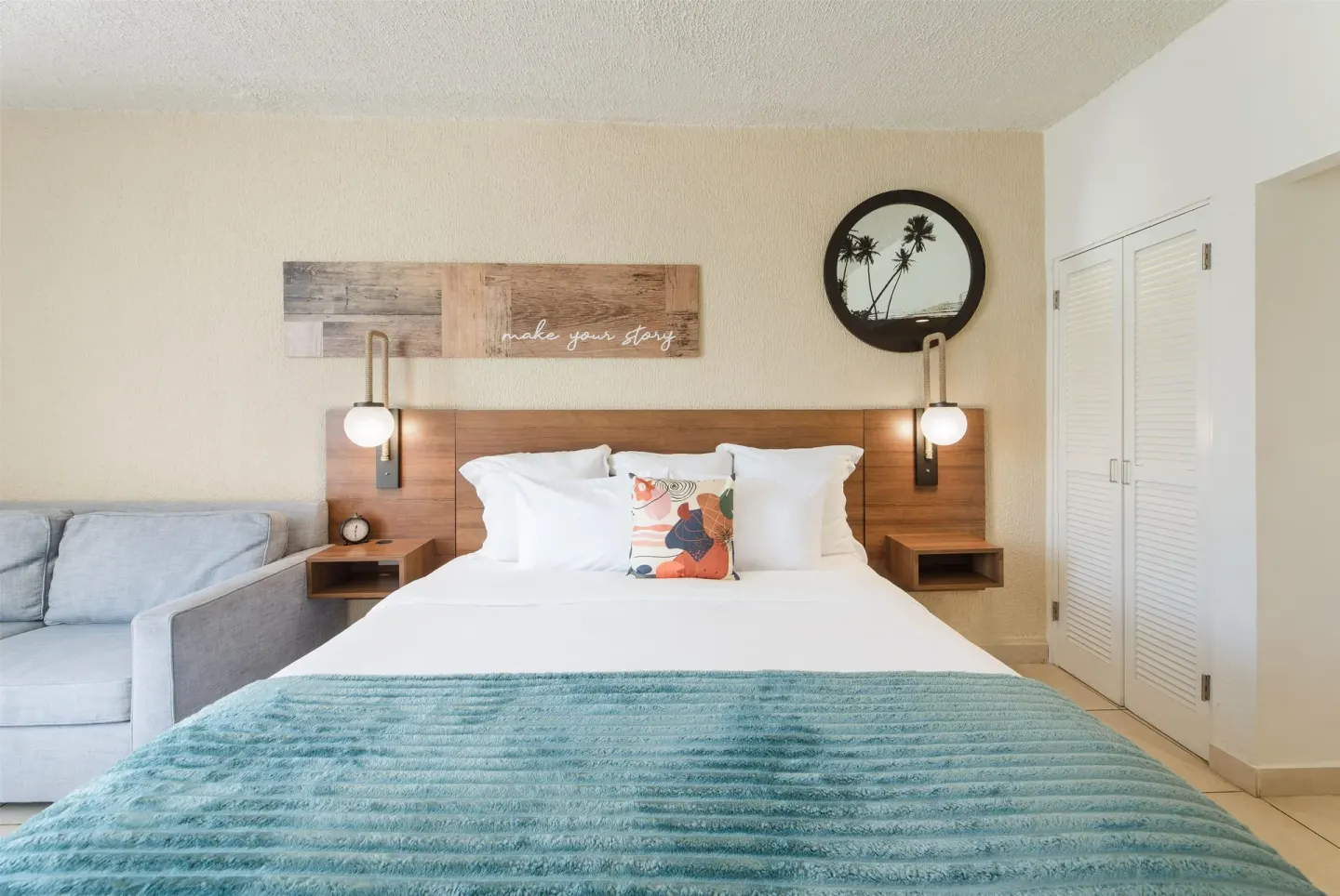 King bed and sofa in a garden view room at Wyndham Palmas Beach and Golf Boutique Resort.