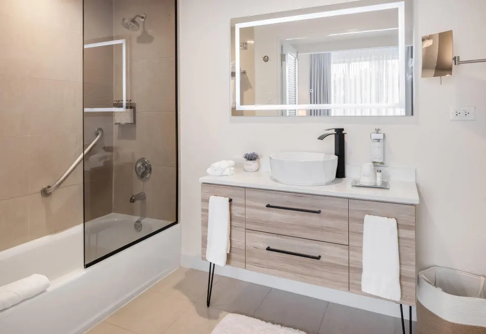 Poolside room bathroom with tub shower and vanity at Wyndham Palmas Beach and Golf Boutique Resort.
