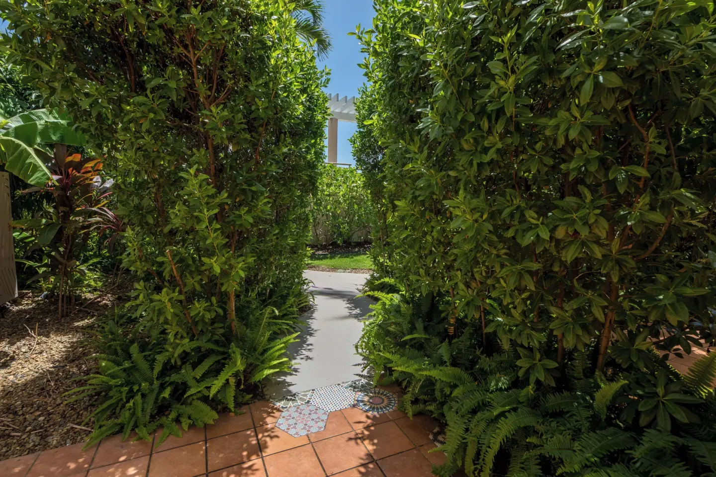 Garden walkway by a poolside room patio at Wyndham Palmas Beach and Golf Boutique Resort.