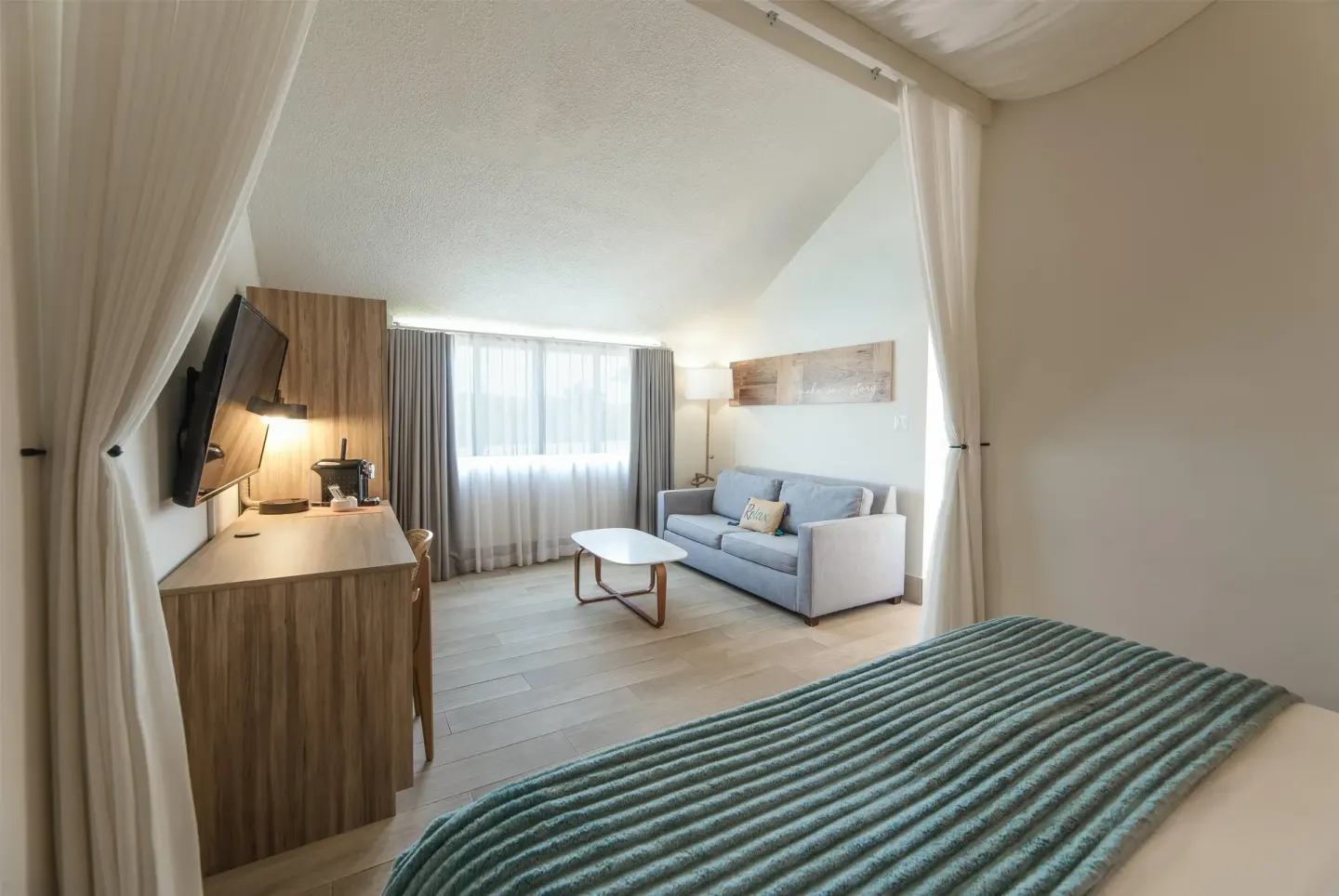 Resort view suite bedroom and sitting area at Wyndham Palmas Beach and Golf Boutique Resort.