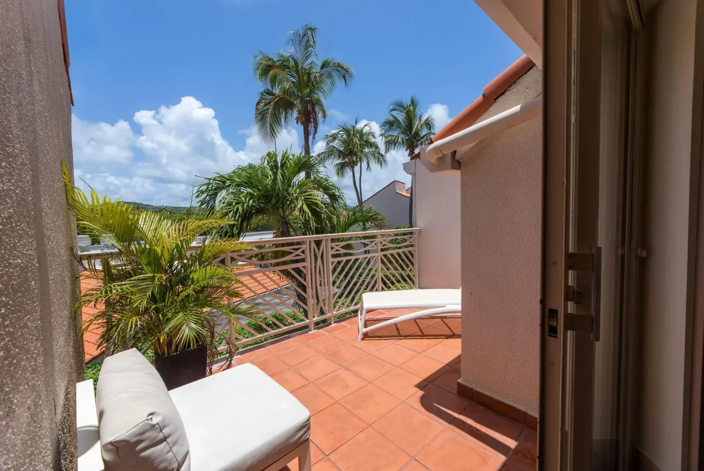 Private terrace with palms outside a suite at Wyndham Palmas Beach and Golf Boutique Resort.