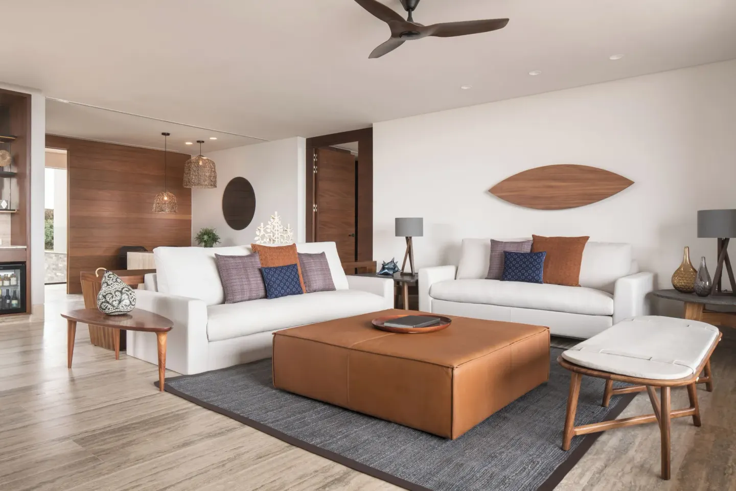 Living room with sofas, ottoman, and ceiling fan at Zadún, a Ritz-Carlton Reserve, Los Cabos.
