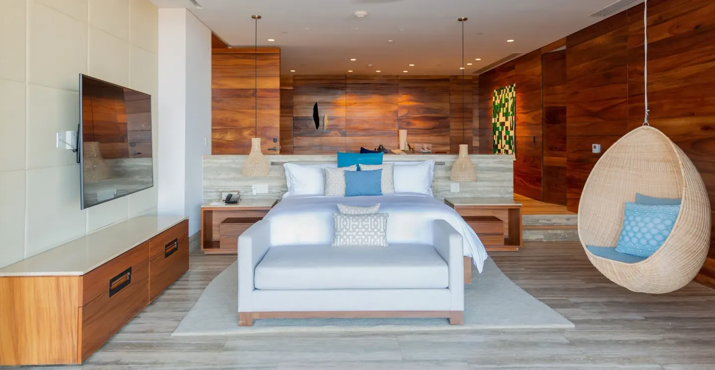 King bed guest room with a hanging chair at Zadún, a Ritz-Carlton Reserve, Los Cabos.
