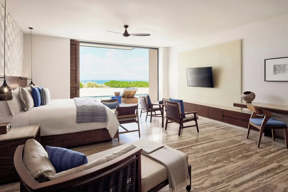 King bed guest room with seating and terrace at Zadún, a Ritz-Carlton Reserve, Los Cabos.