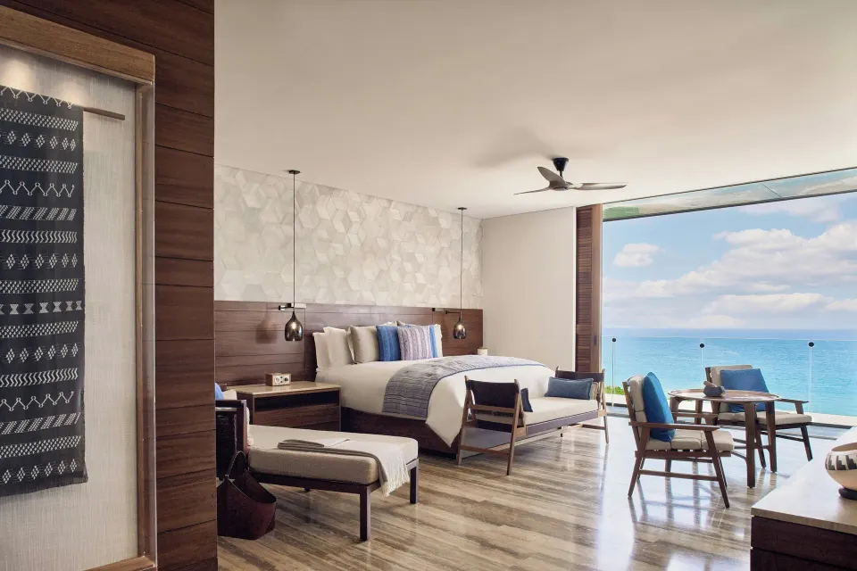 King bedroom with ocean-view seating at Zadún, a Ritz-Carlton Reserve, Los Cabos.