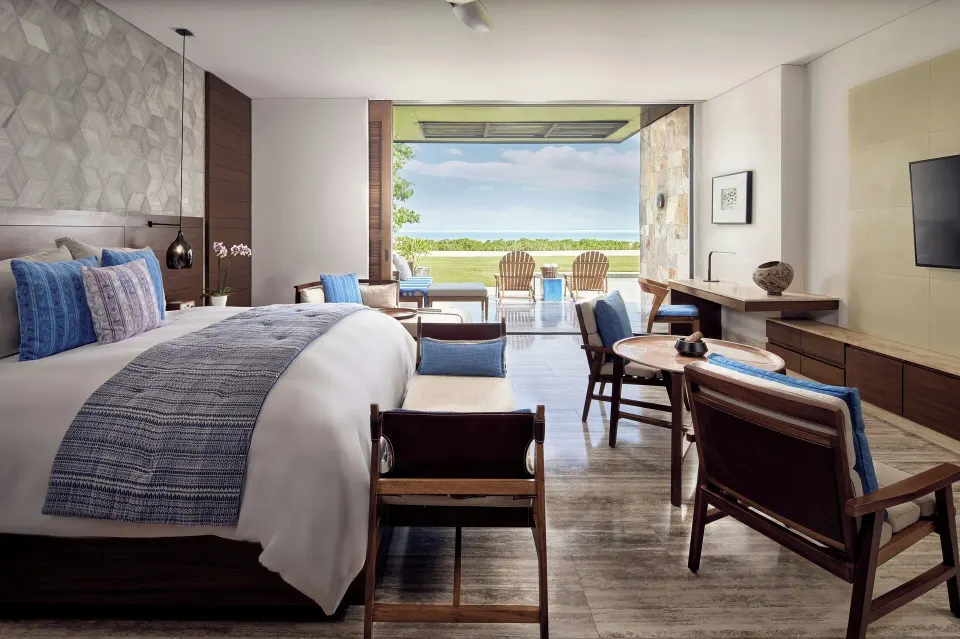 King guest room opening to a lawn and ocean view at Zadún, a Ritz-Carlton Reserve, Los Cabos.