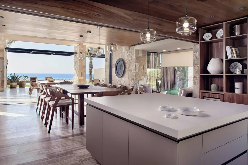Suite kitchen and dining space opening toward the ocean at Zadún, a Ritz-Carlton Reserve, Los Cabos.