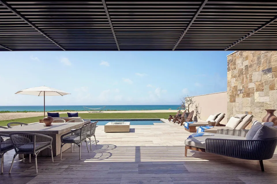 Oceanfront terrace with pool, loungers and dining table at Zadún, a Ritz-Carlton Reserve, Los Cabos.