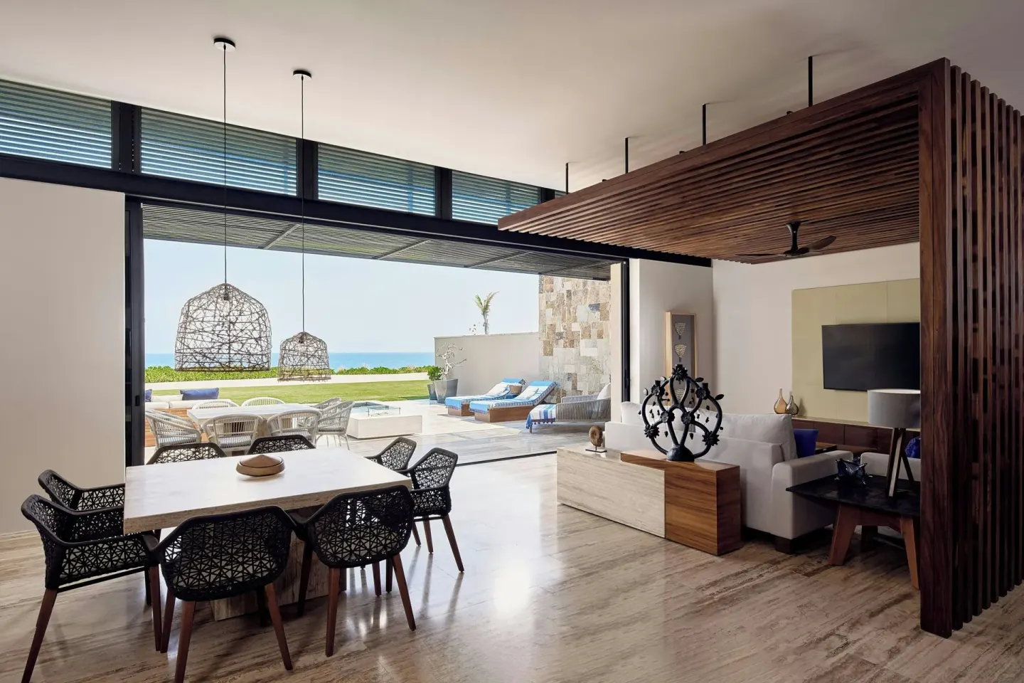 Suite dining and living area opening to a pool terrace at Zadún, a Ritz-Carlton Reserve, Los Cabos.