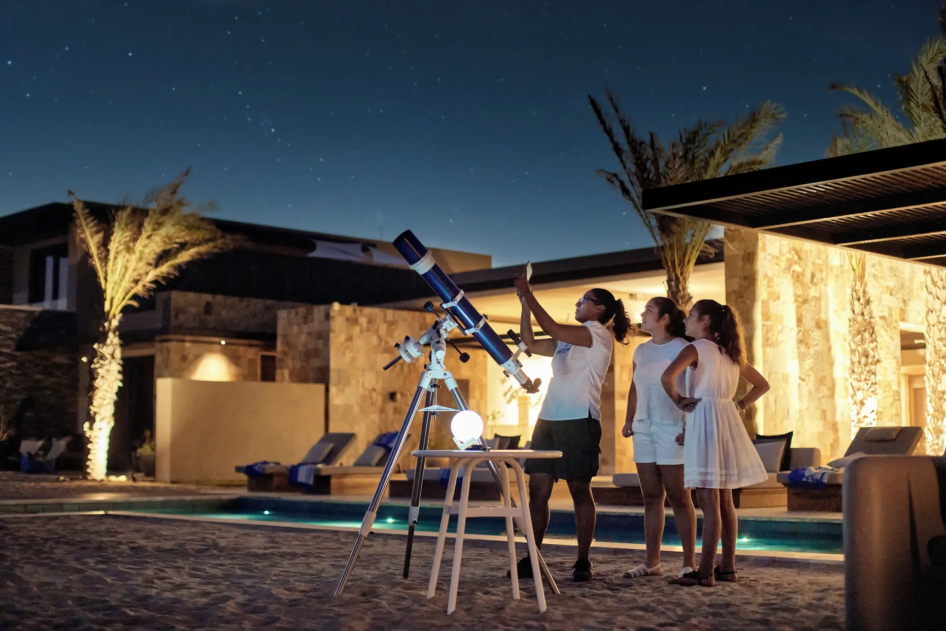 A guide points out stars beside a telescope at Zadún, a Ritz-Carlton Reserve, Los Cabos.