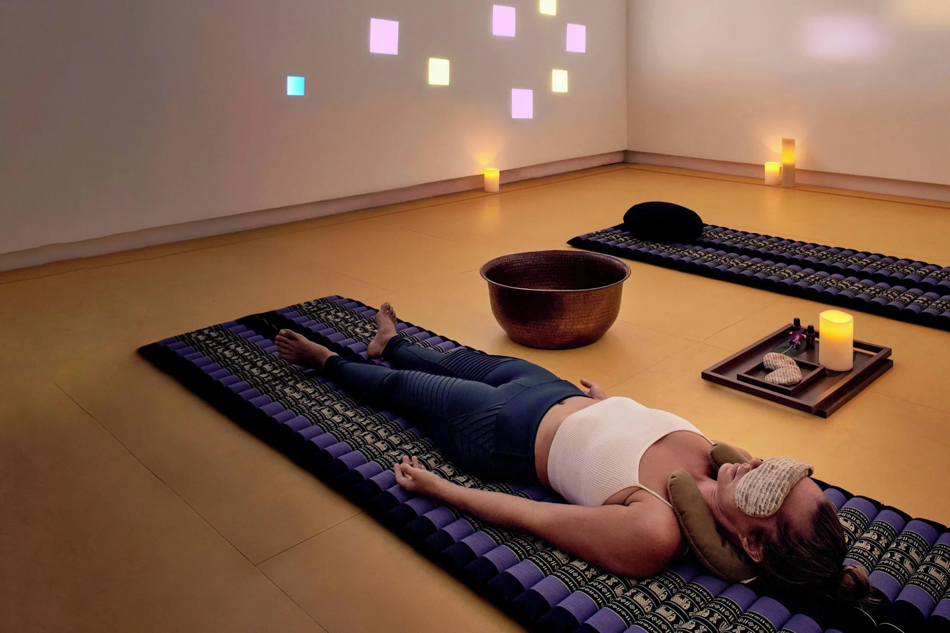 Relaxation room with mats, candles, and colored wall lights at Zadún, a Ritz-Carlton Reserve, Los Cabos.