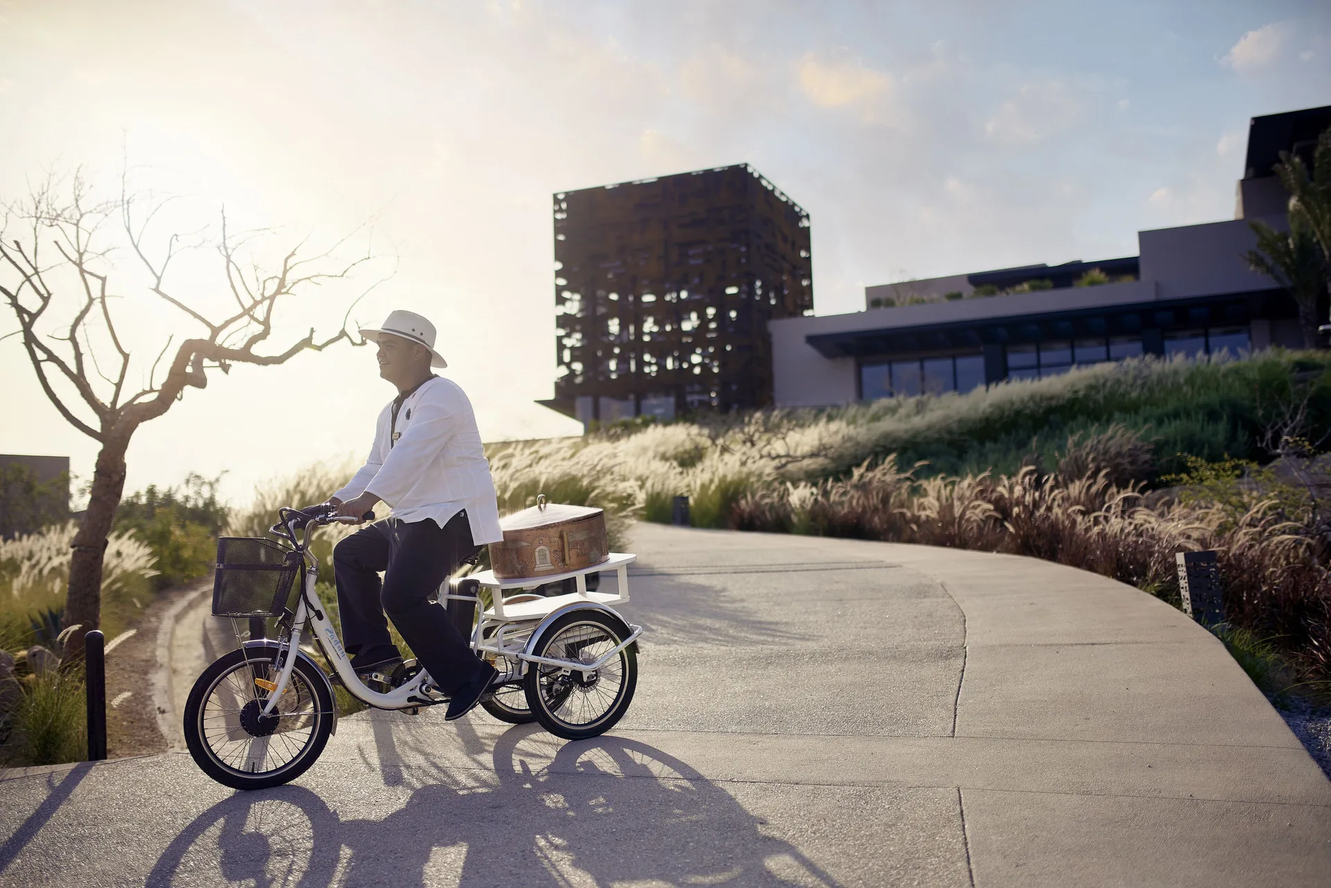 Staff member riding a service tricycle on resort paths at Zadún, a Ritz-Carlton Reserve, Los Cabos.