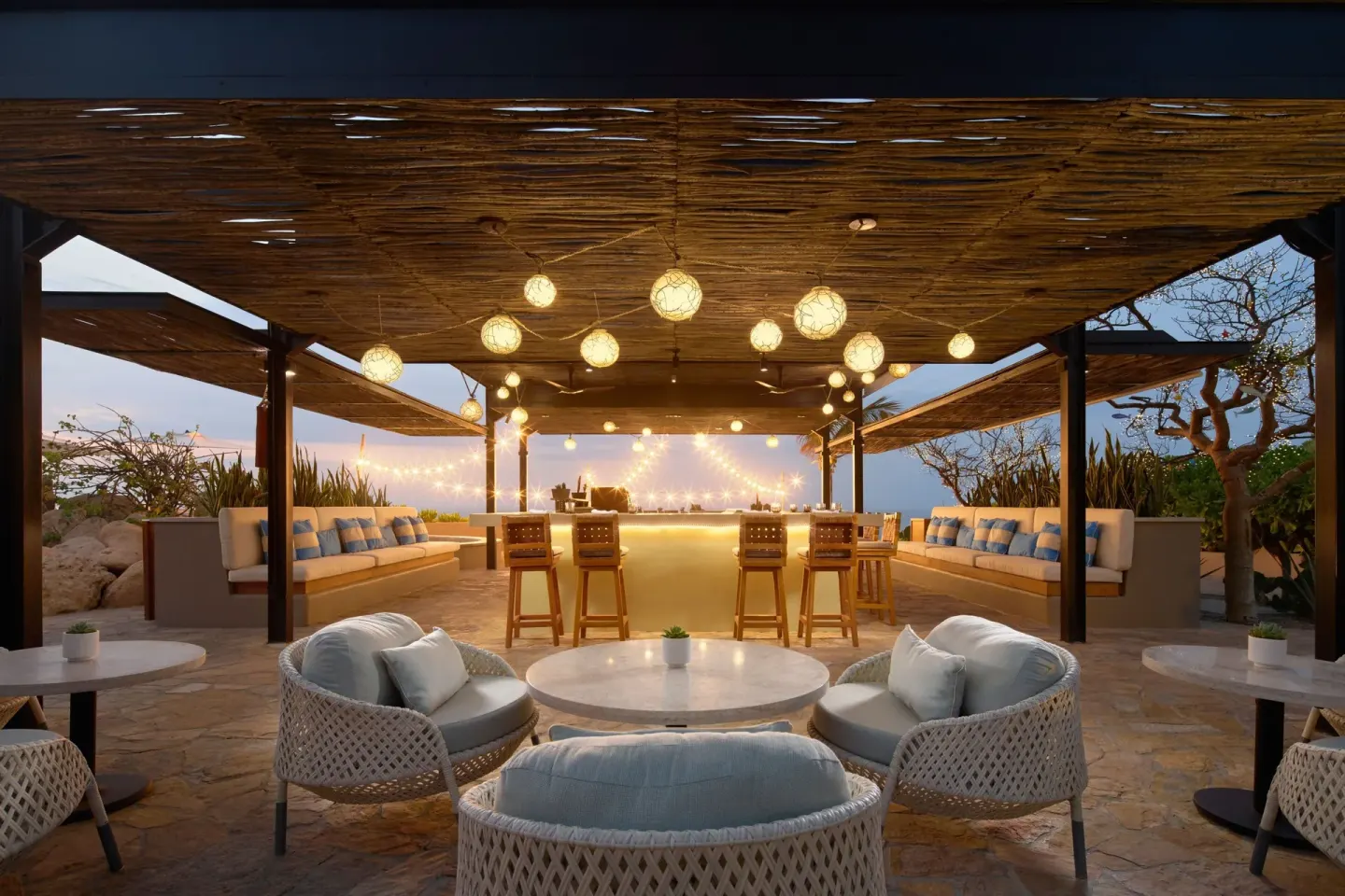 A warmly lit open-air bar lounge at Zadún, a Ritz-Carlton Reserve, Los Cabos.