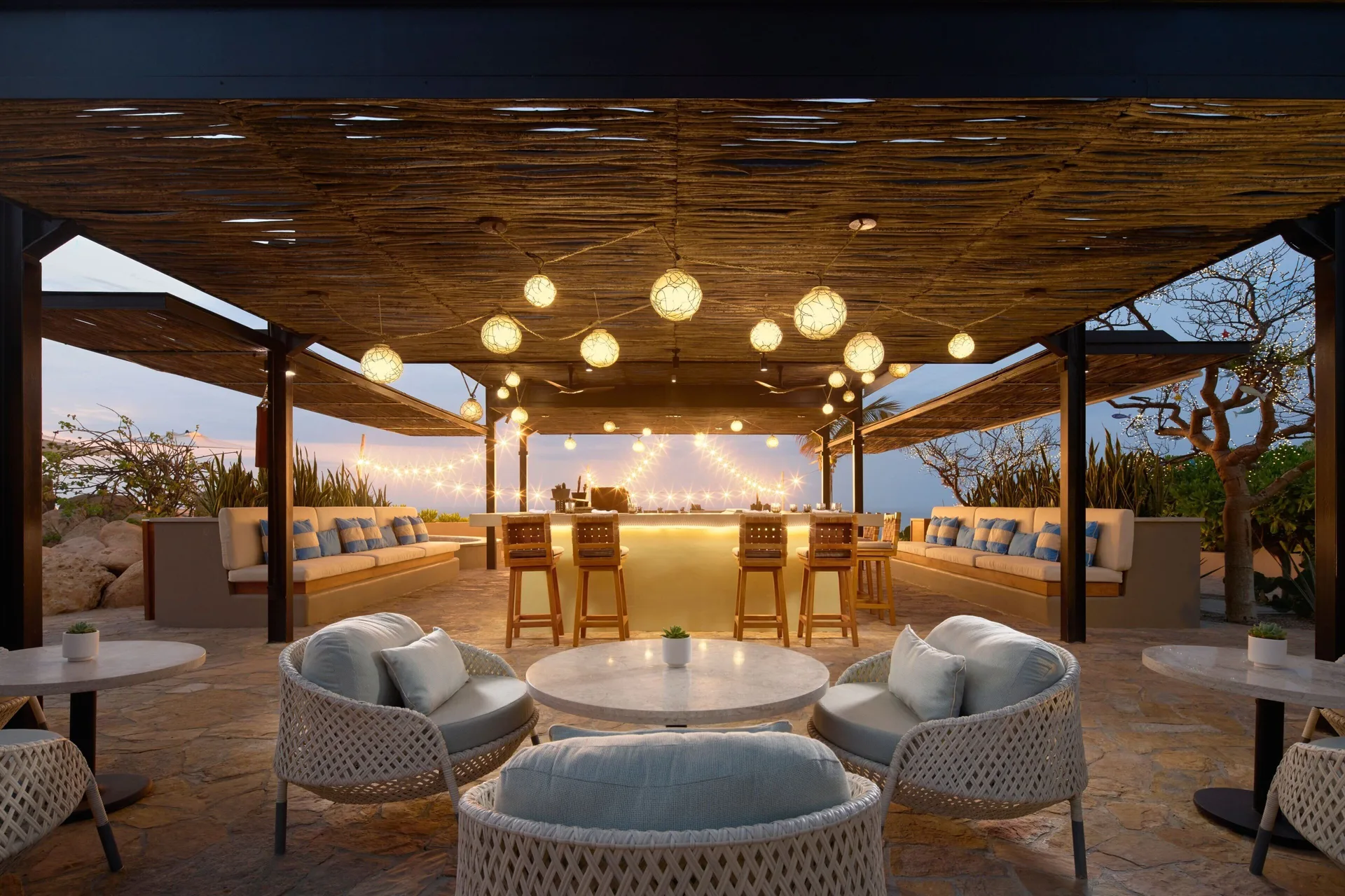 A warmly lit open-air bar lounge at Zadún, a Ritz-Carlton Reserve, Los Cabos.
