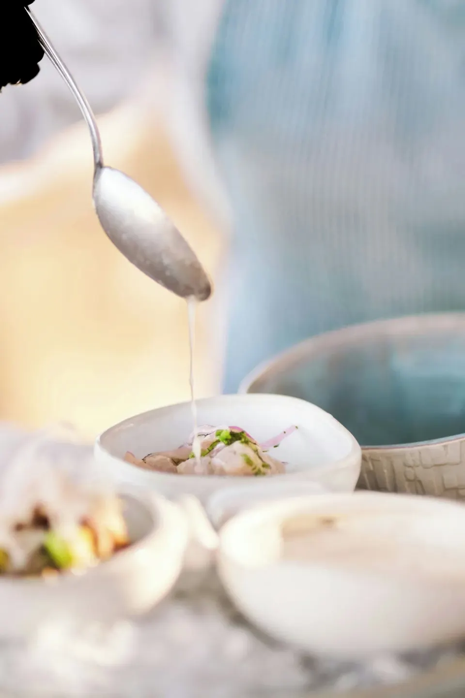 Sauce being spooned over a small seafood dish at Zadún, a Ritz-Carlton Reserve, Los Cabos.