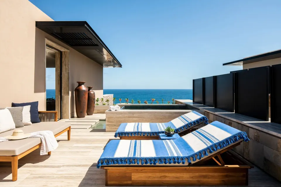 Private ocean-view terrace at Zadún, a Ritz-Carlton Reserve, Los Cabos with loungers and pool.