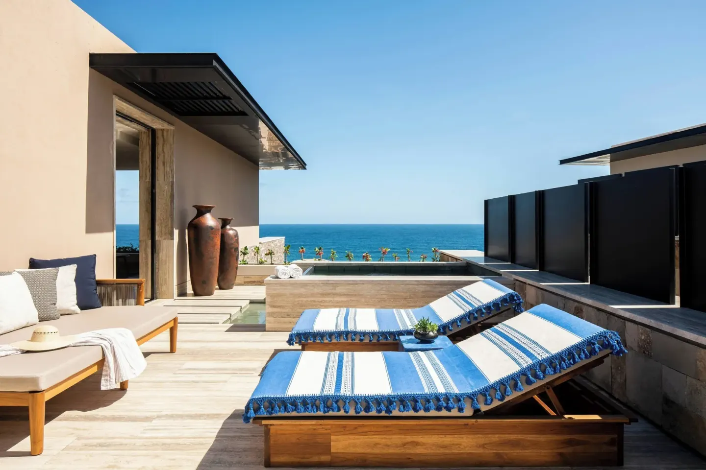 Ocean-view terrace at Zadún, a Ritz-Carlton Reserve, Los Cabos with loungers and a plunge pool.