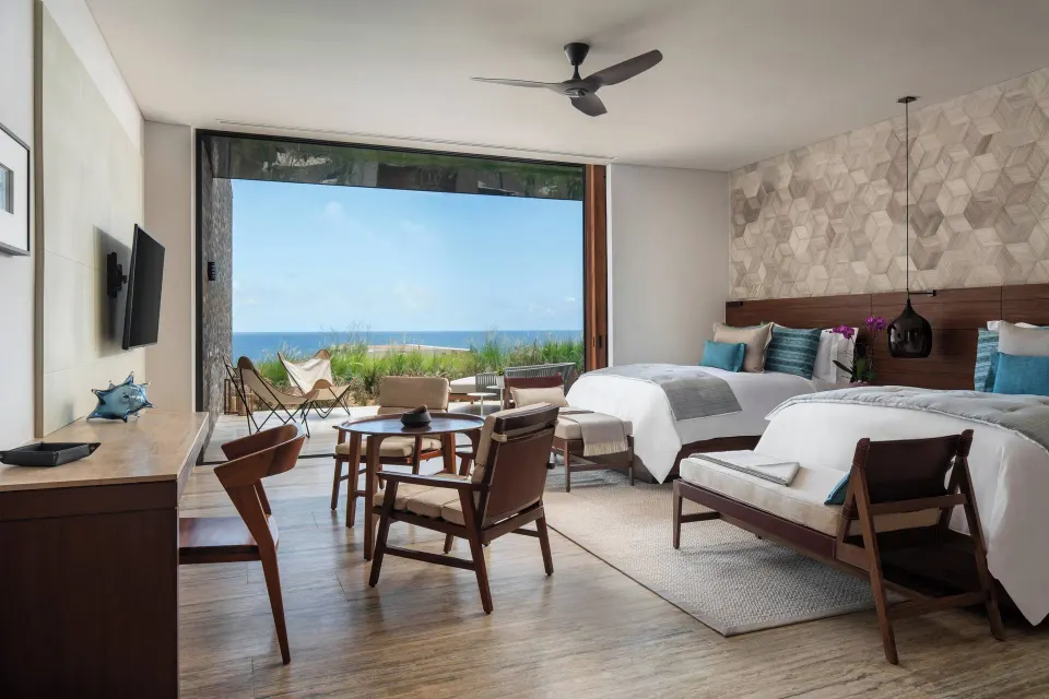 Ocean-view two-bed guest room at Zadún, a Ritz-Carlton Reserve, Los Cabos with seating and terrace.