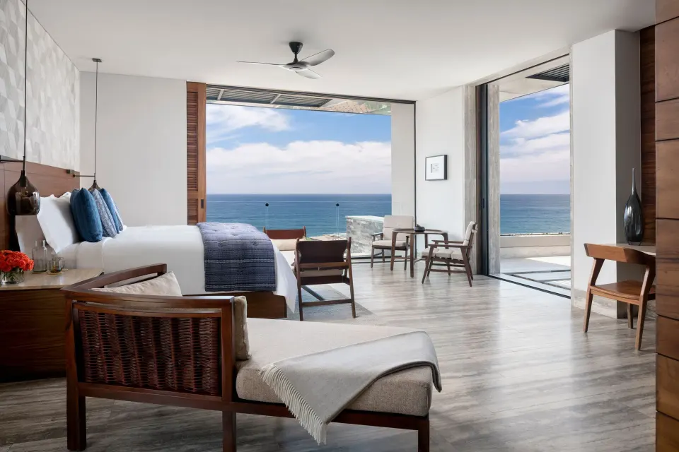 Bright king room with terrace doors and ocean horizon at Zadún, a Ritz-Carlton Reserve, Los Cabos.