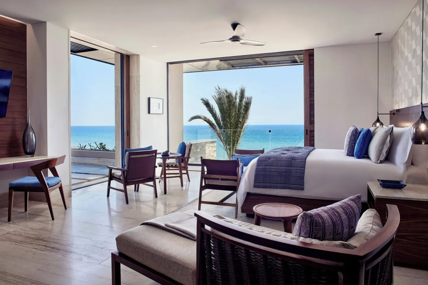 King guest room with open terrace, palm, and ocean view at Zadún, a Ritz-Carlton Reserve, Los Cabos.
