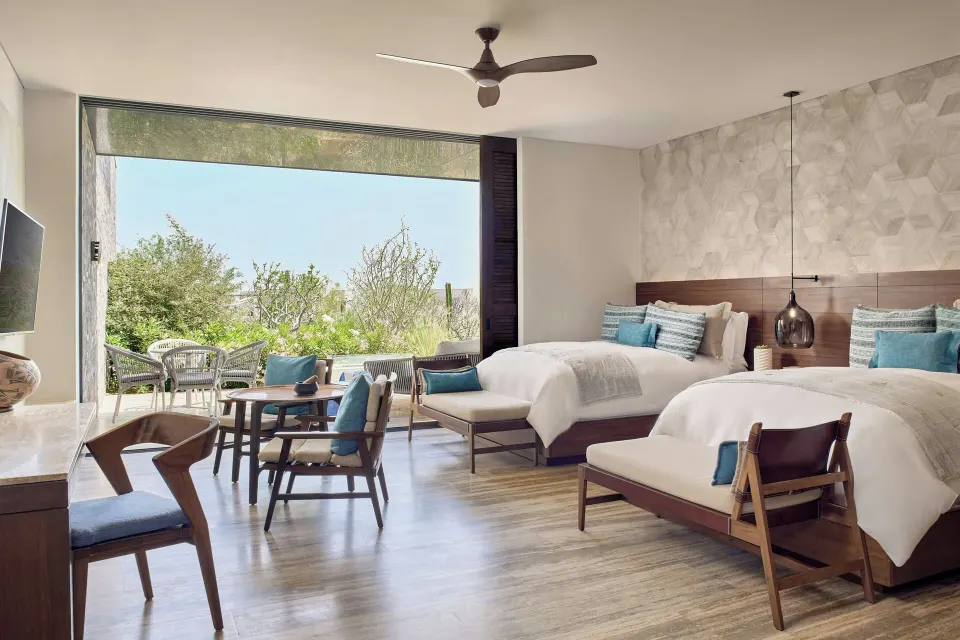 Two-bed guest room with seating area and garden terrace at Zadún, a Ritz-Carlton Reserve, Los Cabos.