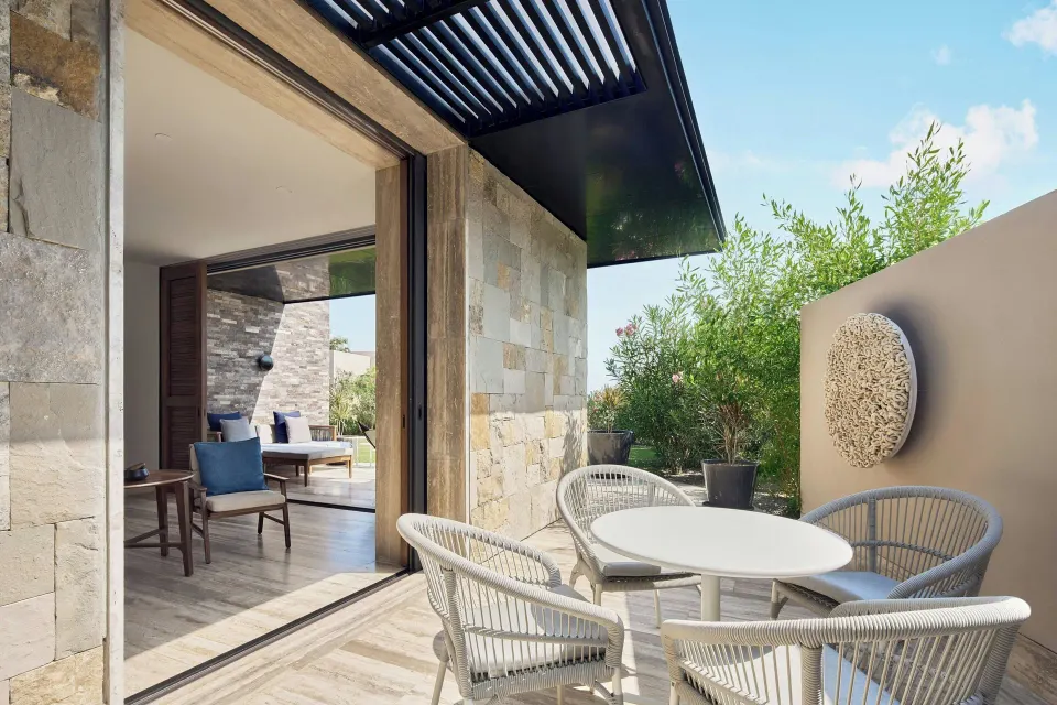 Suite patio with round table and garden wall at Zadún, a Ritz-Carlton Reserve, Los Cabos.