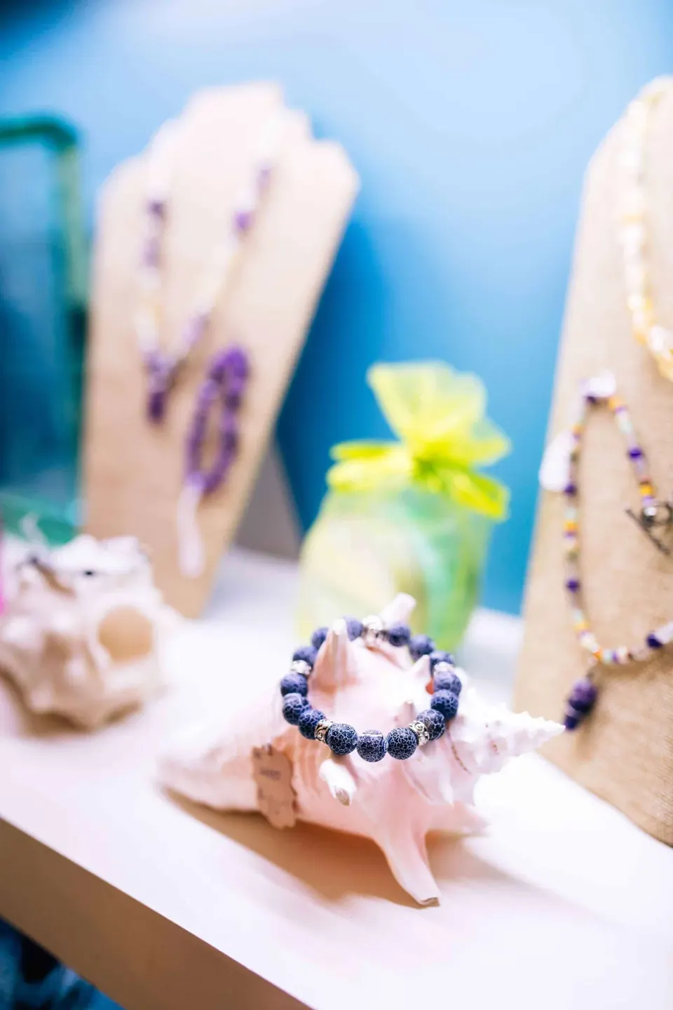 Shells and beaded jewelry displayed on a shelf at Zemi Beach House.