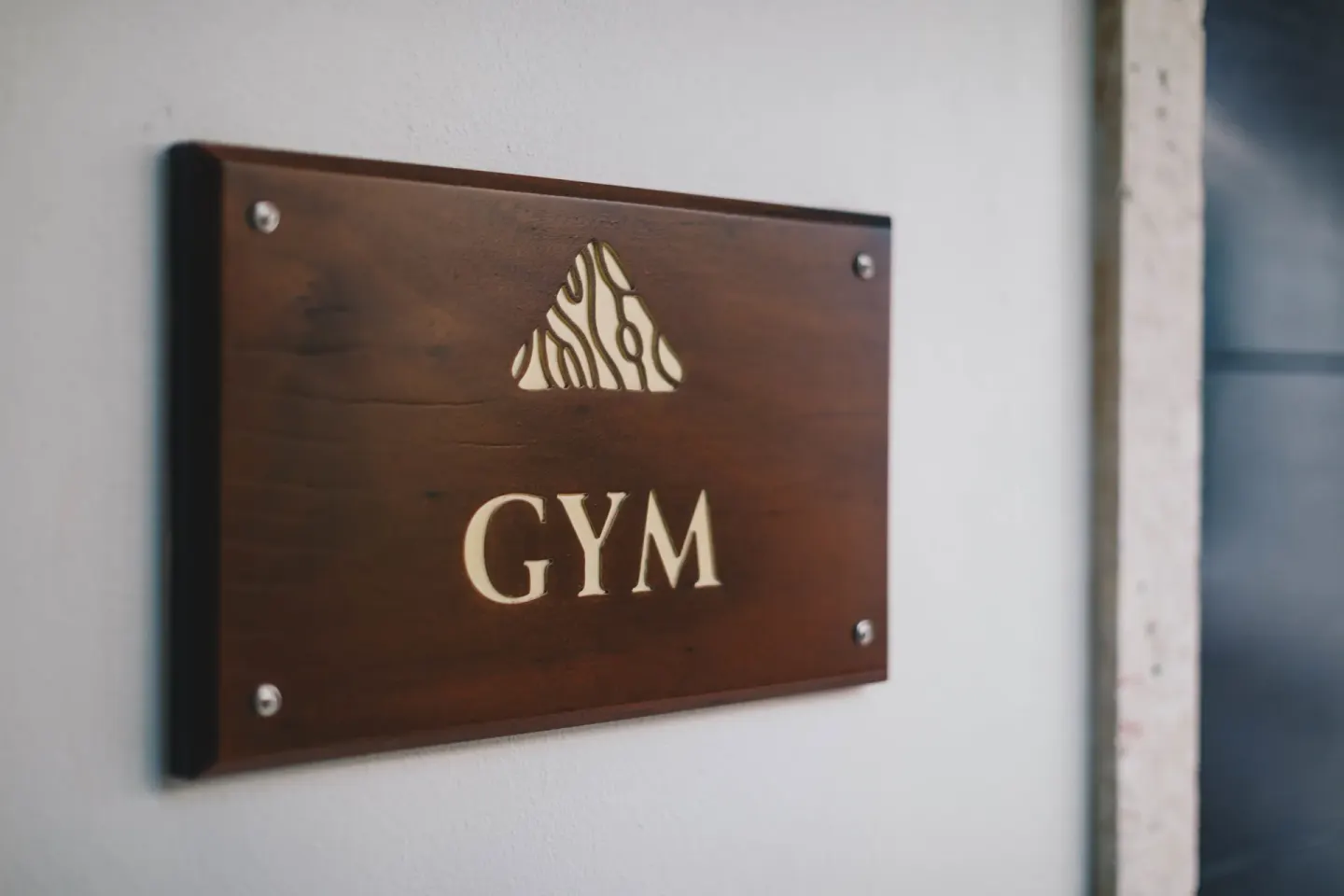 Wooden gym sign mounted on a wall at Zemi Beach House.
