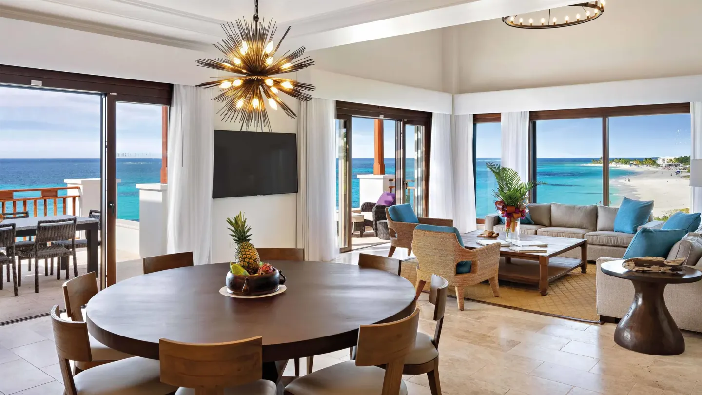 Oceanfront living and dining area with balcony views at Zemi Beach House.