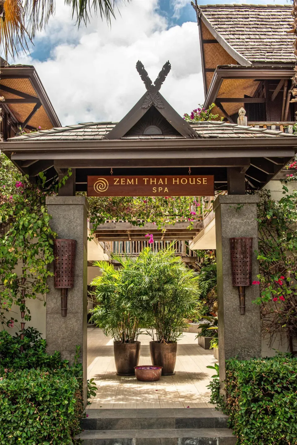 Zemi Beach House gateway with tropical greenery at Zemi Beach House.