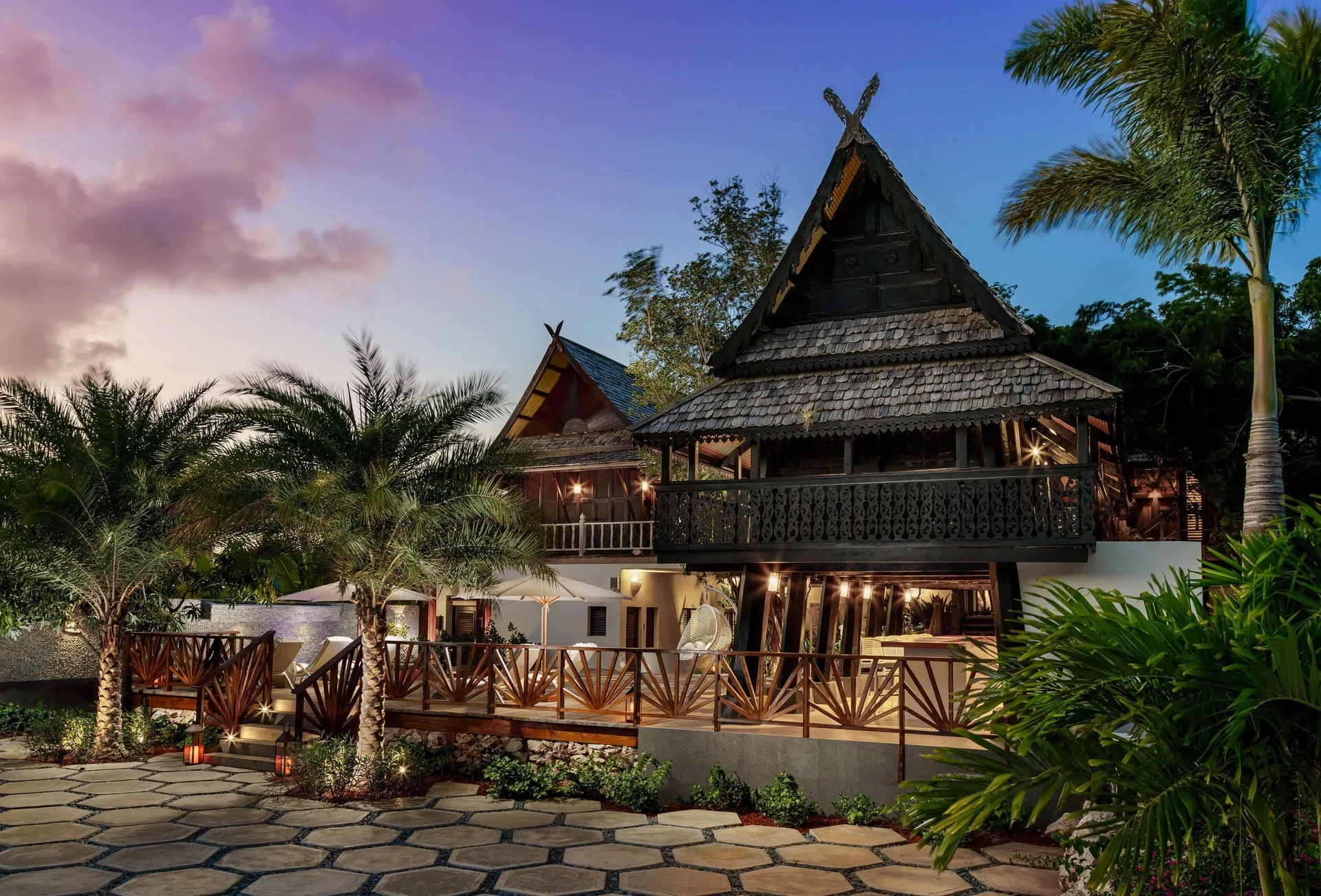 Twilight view of resort buildings and tropical landscaping at Zemi Beach House.