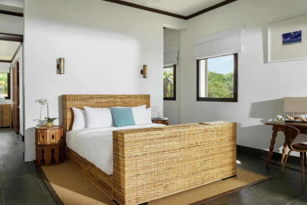 Garden View Room with woven king bed and desk at Zemi Beach House.