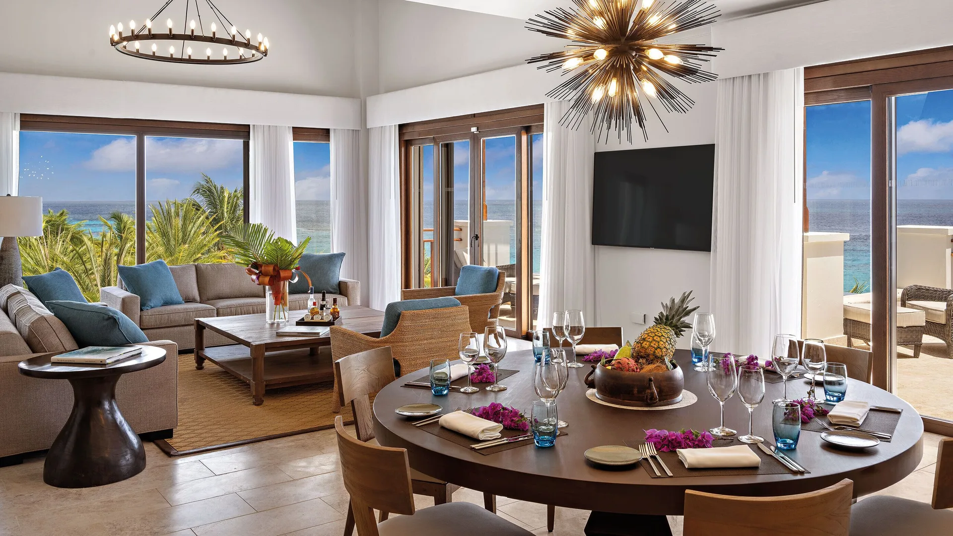 Oceanfront suite living and dining area with balcony views at Zemi Beach House.