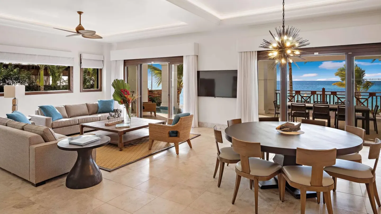 Oceanfront suite living room and dining table opening to a balcony at Zemi Beach House.