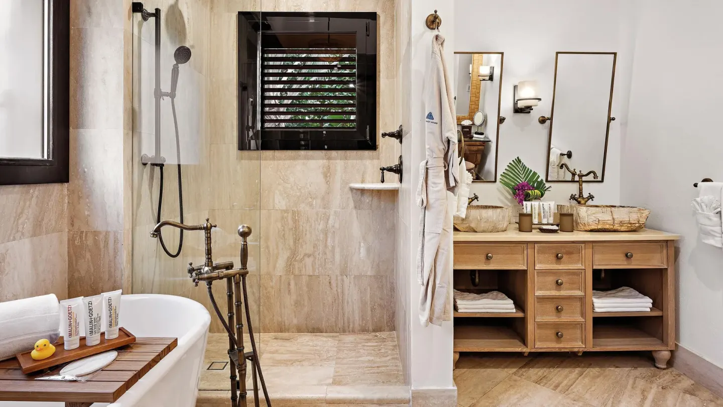 Ocean View room bathroom with tub, shower, vanity, robe, and bath tray at Zemi Beach House.