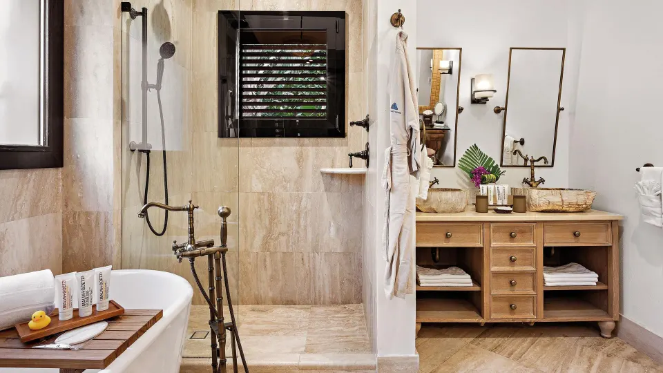 Ocean View room bathroom with tub, shower, vanity, robe, and bath tray at Zemi Beach House.