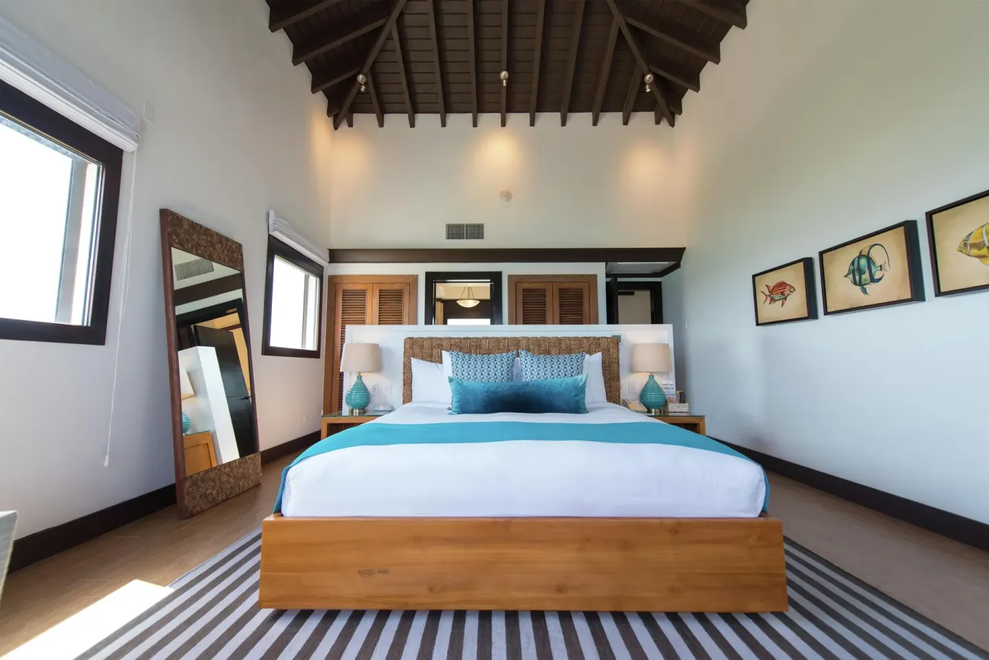 Ocean View room king bed beneath a vaulted wood ceiling at Zemi Beach House.