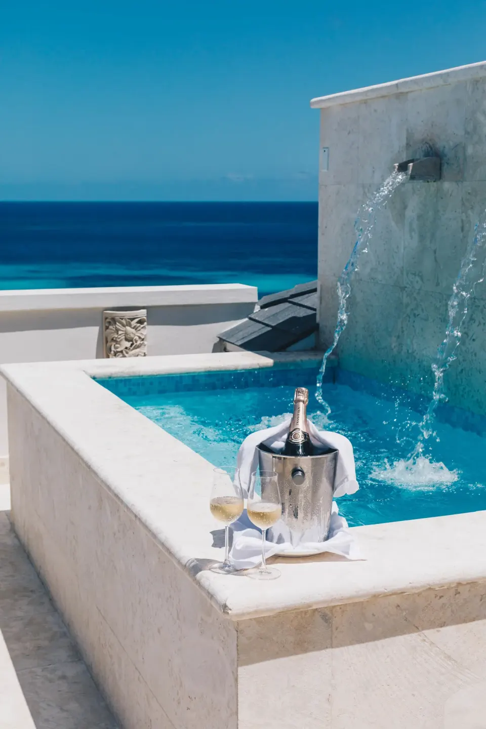 Ocean View room plunge pool with water feature and champagne by the sea at Zemi Beach House.
