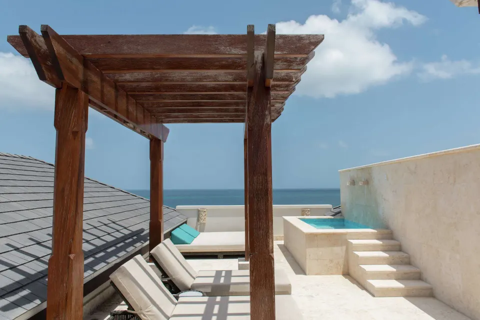 Ocean View room terrace with pergola, loungers, plunge pool and sea view at Zemi Beach House.